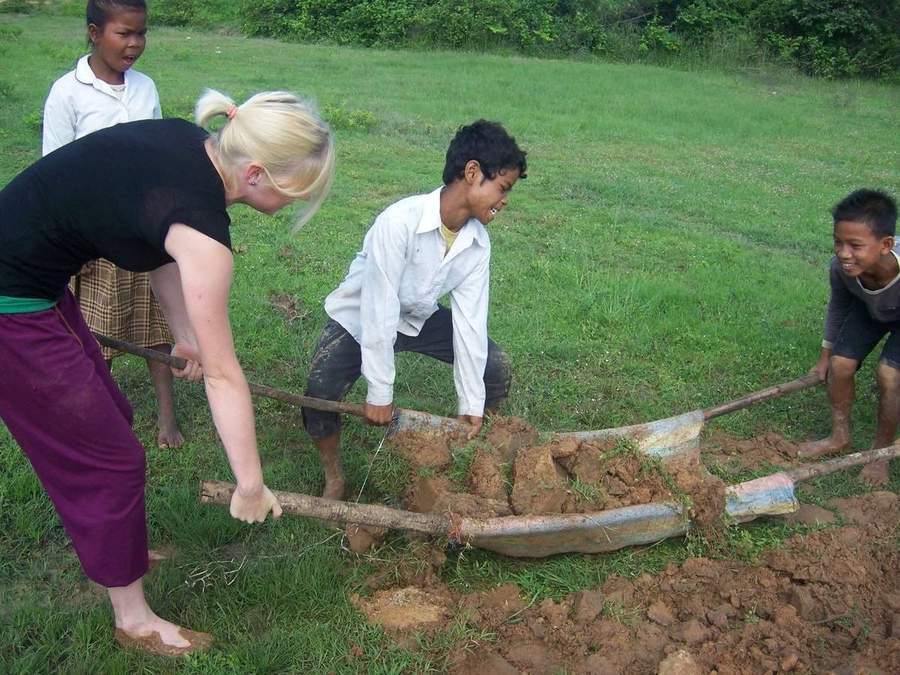 Volunteer plowing field with local farmers and oxen