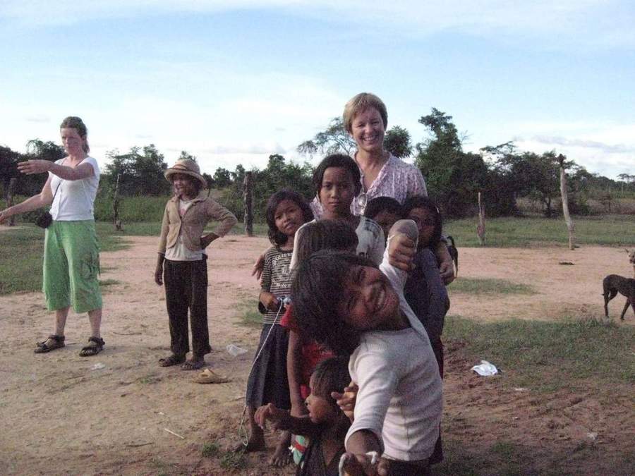 Volunteers and local children gathered on dirt clearing