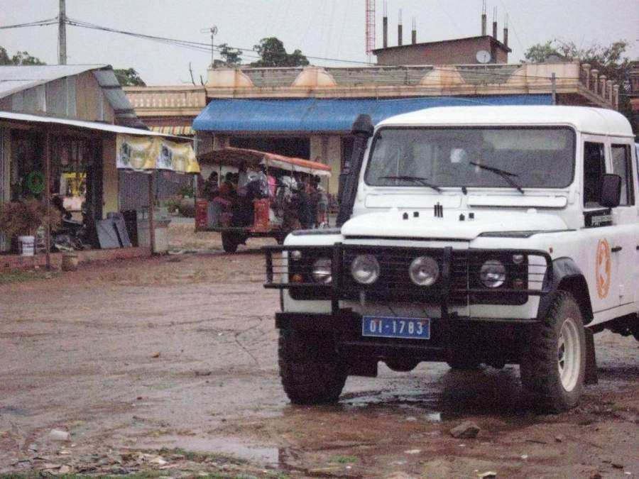 GSO Land Rover parked in village with children nearby