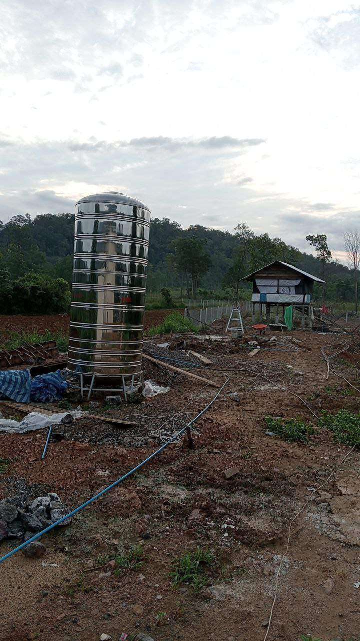 Large stainless steel water tank at construction site