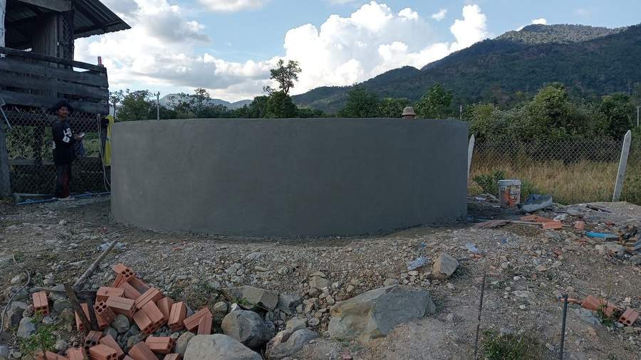 Large circular concrete fish pond under construction