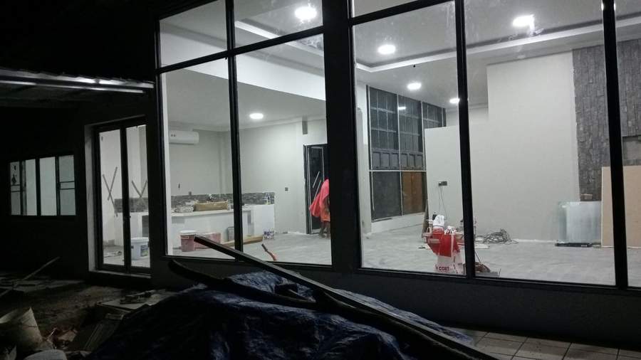 Modern building under construction with glass windows at night