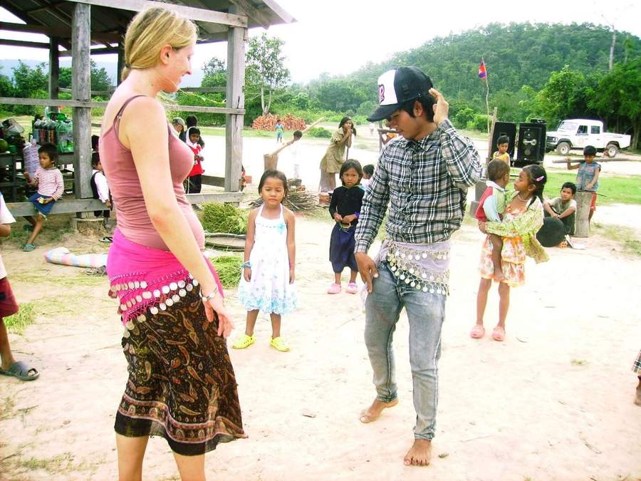 Blonde woman and young man dancing at village celebration