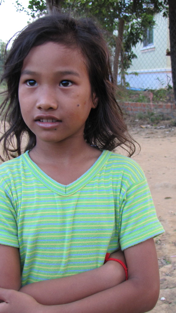 Close-up portrait of young Cambodian girl in striped shirt