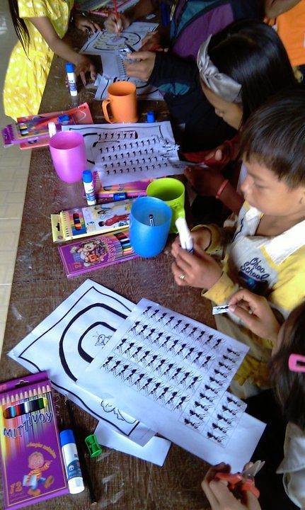Children doing art and coloring activity at classroom table
