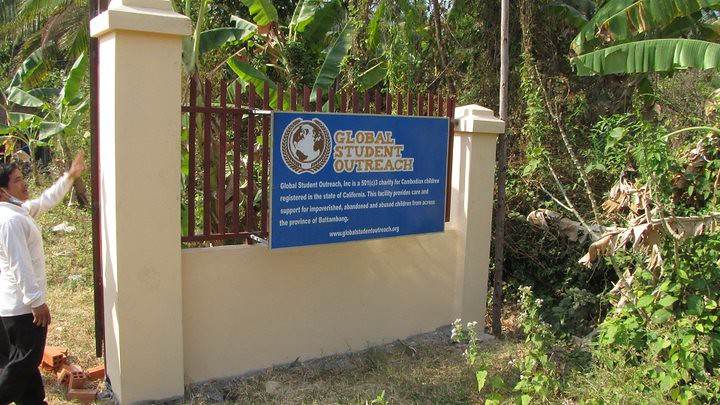 Blue Global Student Outreach sign on building wall