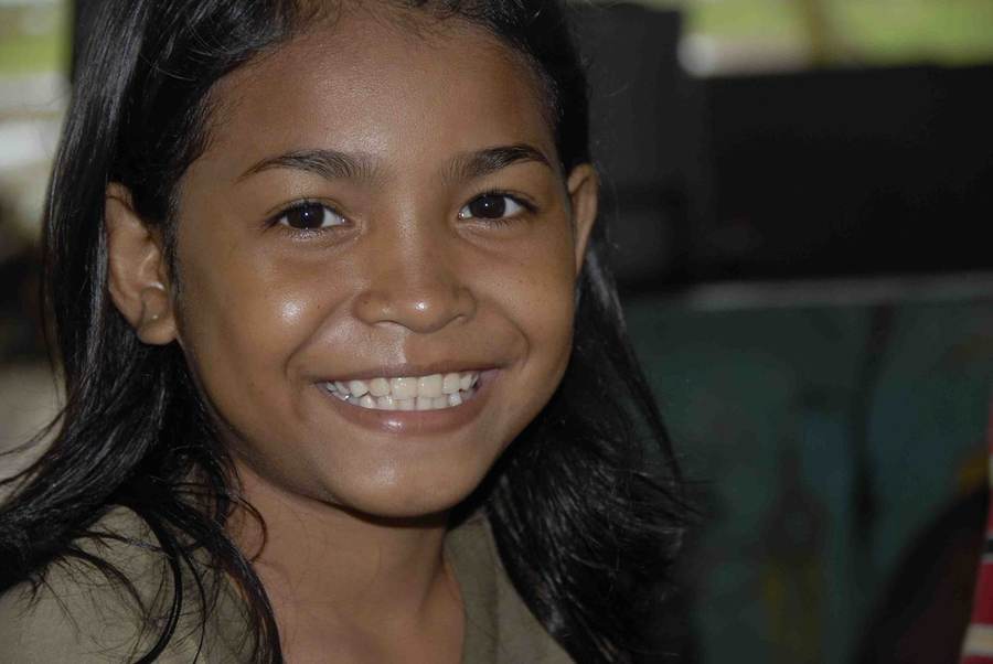 Close-up of smiling girl with dark hair