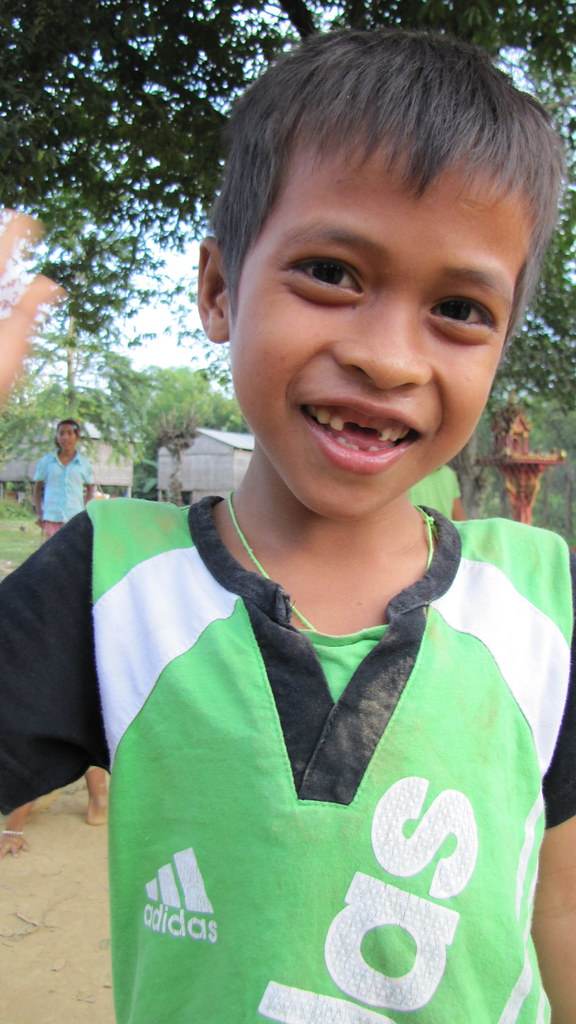Smiling young boy in green soccer jersey close-up portrait
