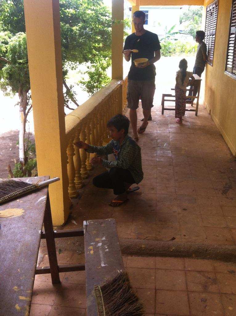 Volunteer and children at school renovation